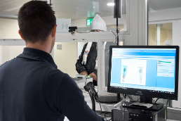 The fingerprints of an asylum seeker appear on a computer screen and are checked by a SEM staff member.