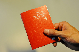 Hand holds Swiss passport